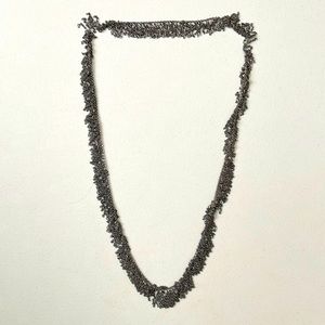 Long silver chain-like necklace